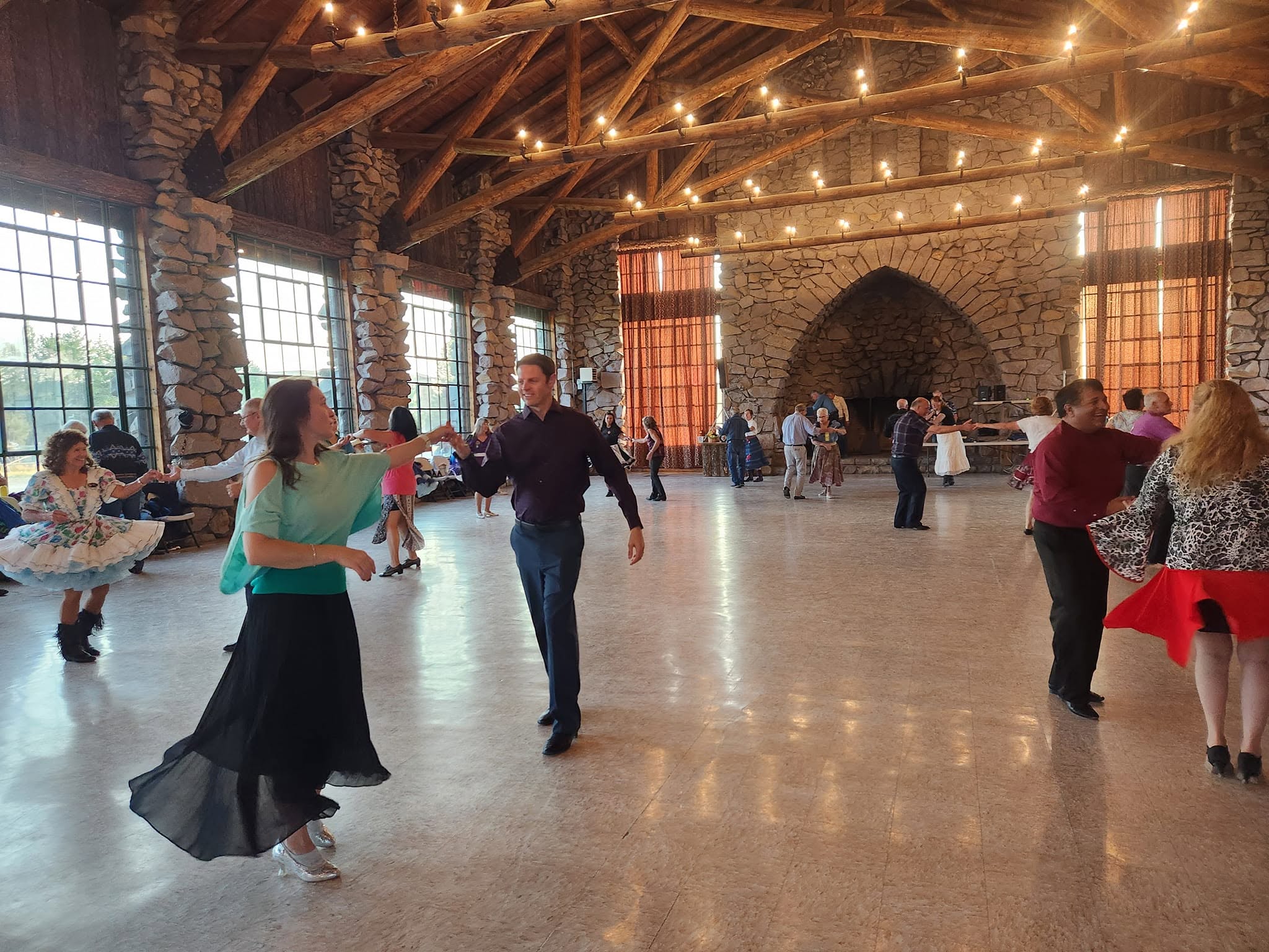 Dancers sharing the floor beneath the lodge's timber beams